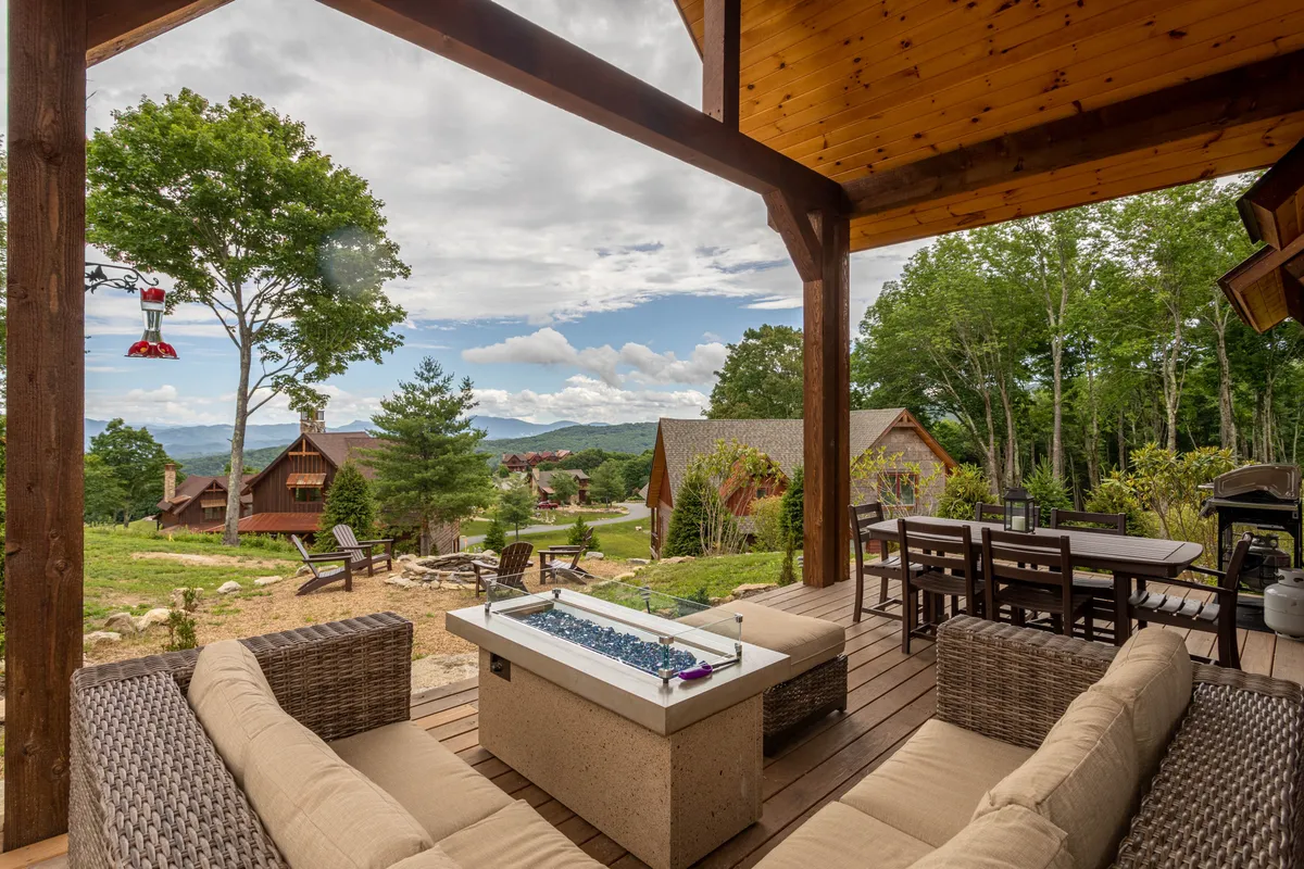 A cozy outdoor fire pit area with comfortable seating arranged to take in panoramic mountain views. The scene is serene and inviting, perfect for evening gatherings, storytelling, and unwinding under the stars.